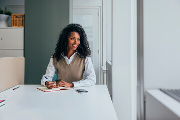 Black businesswoman focused on work in modern office space