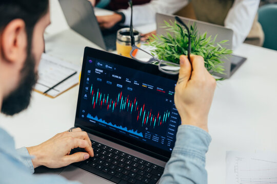 Analyzing financial crypto data on a laptop in an office