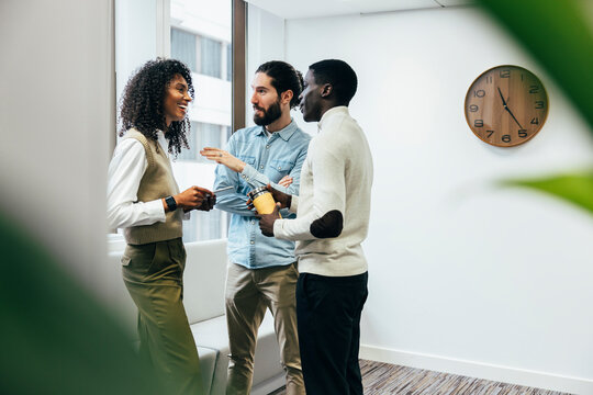 Diverse Team Engaging in Discussion in Modern Office