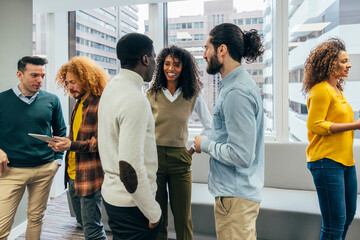 Diverse team engaging in a discussion in a modern office