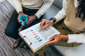 Casual business meeting with charts and coffee