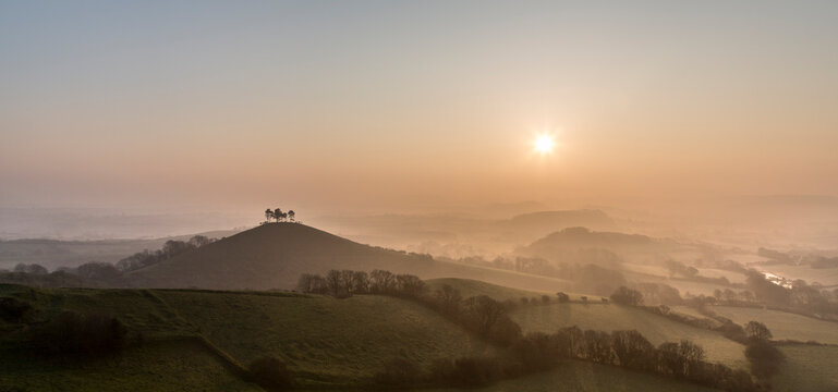Sunrise over the hills and misty valleys of England