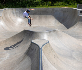 Boy jumping on a skateboard.