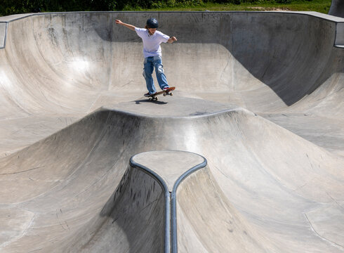 Boy jumping on a skateboard.