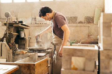 Man Applying Powder to Make Cement Tiles in a Factory During Workday