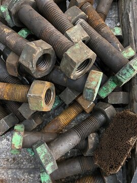 Rejected and rusted nut bolt lying on  floor