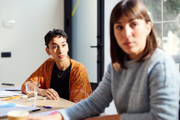 Two attentive businesswomen during a conversation in the office