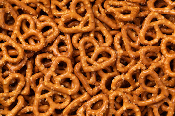 Salted pretzel hearts full frame as background close up