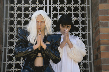 Ying and yang, women in costumes posing outside an old church