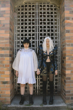 Ying and yang, women in costumes posing outside an old church