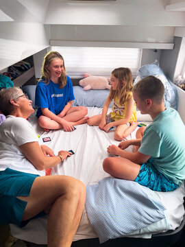 UGC Family Travel together Grandmother playing cards on boat 