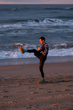 Straching before morning run on the beach.