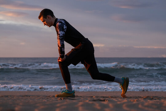 Straching before morning run on the beach.