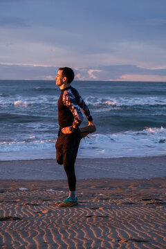 Straching before morning run on the beach.
