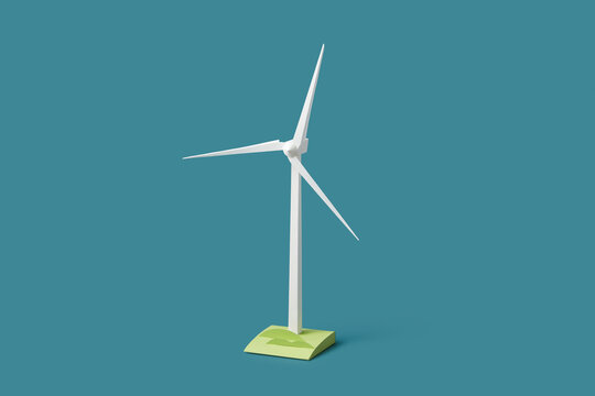 Windmill standing on piece of field isolated on blue studio background