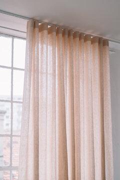 Soft, sheer curtains with a glimpse of a window