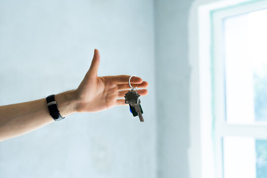 Close up of male hand hold bunch of key of new home