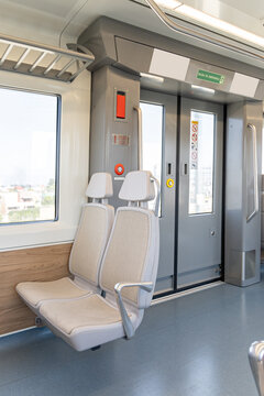Empty seats next to an automatic door inside an electric train