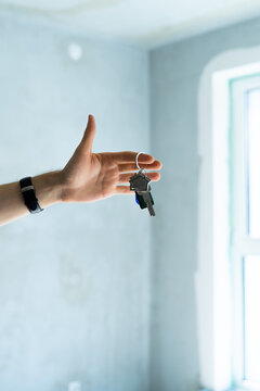 Close up hand with home key. Real estate, relocation, buying new house