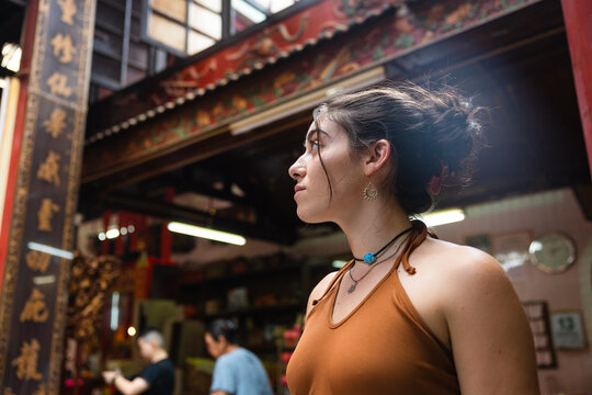 Young woman admiring Chinese culture in a temple