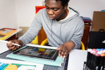 Serious teenager working on tablet