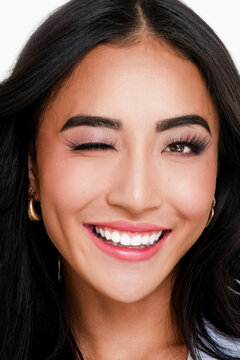 A radiant joyful portrait of a woman winking at camera