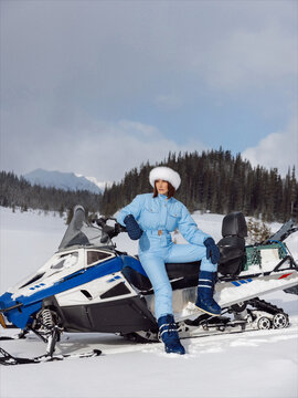 Woman sitting on the snowmobile