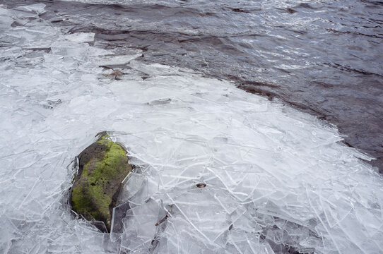 Detail of broken ice on the shore of a lake in winter