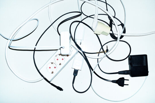 Wires, chargers and cords on a business office floor with flashlight