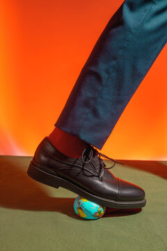 Businessman Stepping on Globe