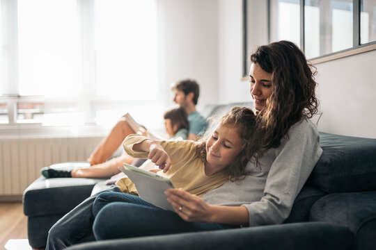 family using table device at home