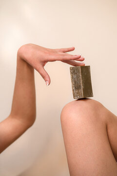 Nude woman with natural bar soap on skin