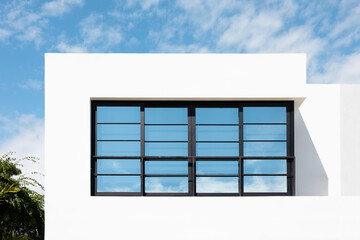 Modern architecture with large window against blue sky