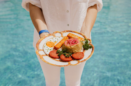 Poolside breakfast served by person in casual attire