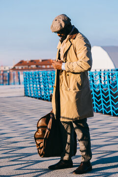 Stylish Man in Trench Coat Checking Time