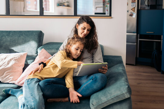 family using table device at home