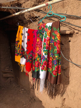 Floral Scarfs of Abyaneh Against Earthen Wall

