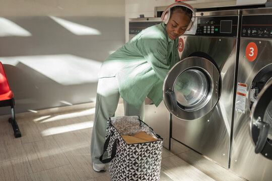 black woman doing laundry in the laundry