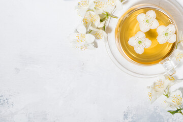 cup of fresh fragrant green tea with jasmine and white background