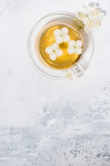 cup of fresh fragrant green tea with jasmine and white background, vertical