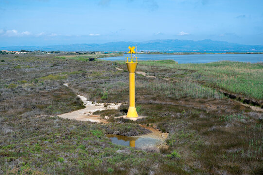 Yellow lighthouse in El Garxal, Ebro Delta, Riumar, Catalonia. Spain