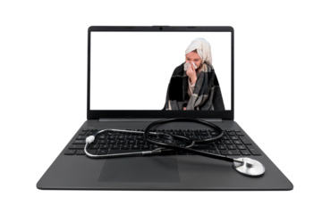 Laptop and medical stethoscope isolated on transparent background. On the laptop screen - a girl with cold symptoms blows her nose into a paper handkerchief