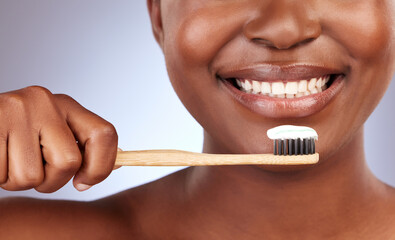 Toothpaste, smile and woman with bamboo toothbrush in studio with oral care and hygiene routine....