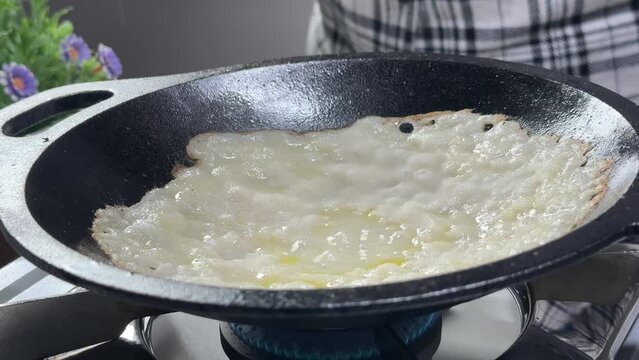 Women making or cooking Appam Palappam Kallappam vella appam made of rice batter plain hoppers