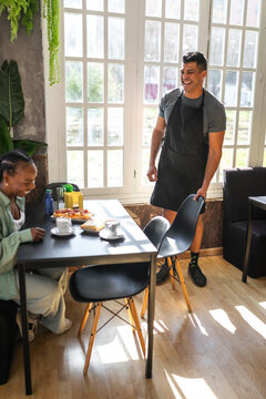 black woman having breakfast in a cafe