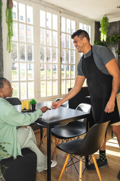 black woman having breakfast in a cafe