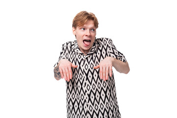 young red-haired caucasian man in a short-sleeved summer shirt makes a grimace