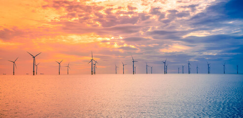 Sunset Offshore Wind Turbine in a Wind farm under construction of England coast, UK