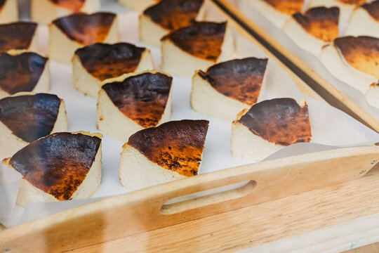 Slices of basque cheese cakes at the window display at local bakery, Bilbao, Spain