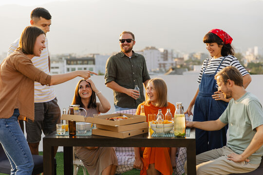 Laughing friends enjoying rooftop party